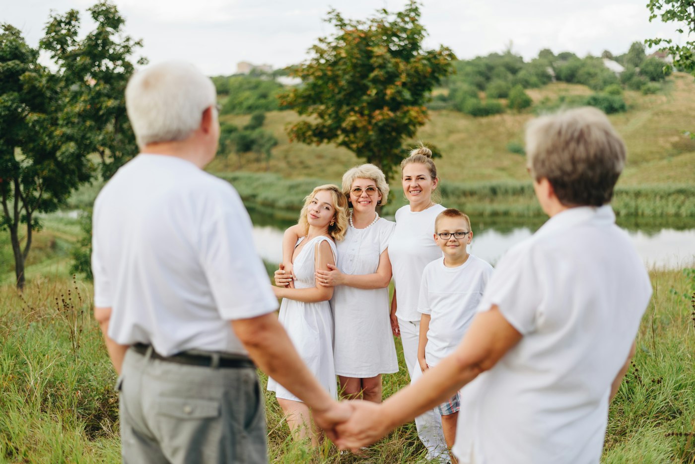 A family standing together outdoors on a sunny day